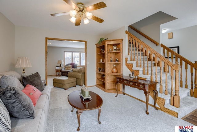 carpeted living room featuring stairs, a ceiling fan, and baseboards