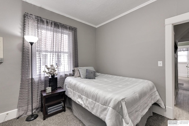 bedroom featuring a textured ceiling and crown molding