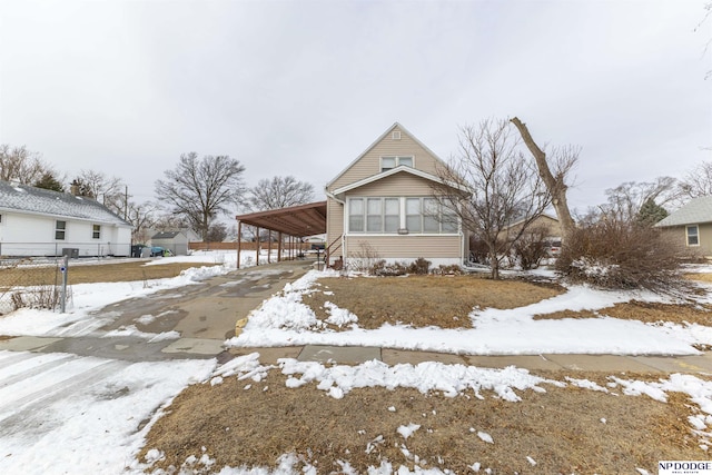 view of front of home featuring a carport and fence