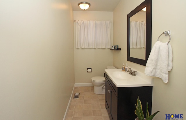 bathroom featuring baseboards, visible vents, toilet, tile patterned flooring, and vanity