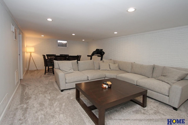 living area with light carpet, visible vents, brick wall, crown molding, and recessed lighting