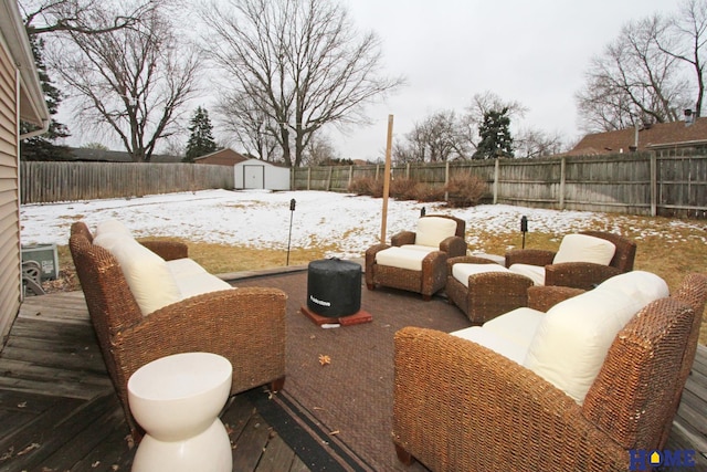 exterior space with an outbuilding, a storage unit, an outdoor hangout area, and a fenced backyard