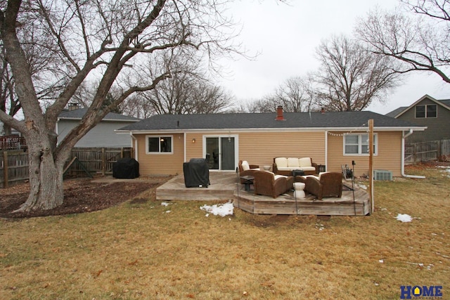 rear view of house with a yard, a chimney, fence, and an outdoor living space