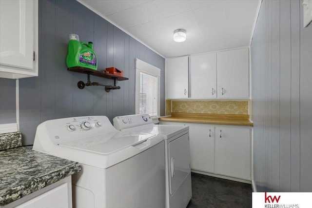 laundry area featuring washer and dryer, cabinet space, and crown molding