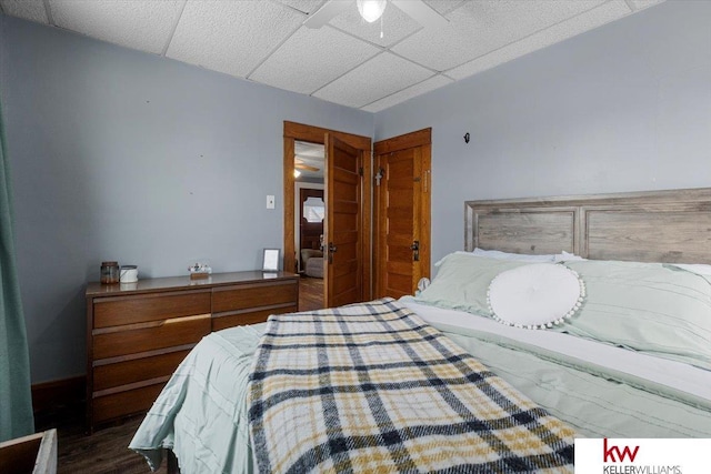 bedroom featuring a paneled ceiling and wood finished floors