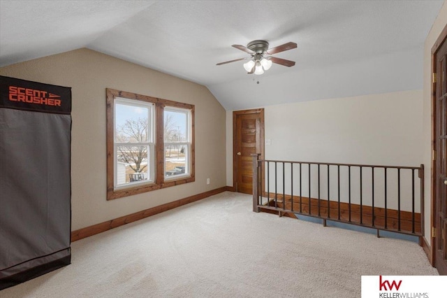 additional living space with lofted ceiling, a ceiling fan, baseboards, and carpet flooring