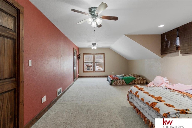 carpeted bedroom with lofted ceiling, visible vents, a textured wall, ceiling fan, and baseboards