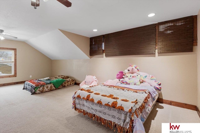 carpeted bedroom with vaulted ceiling, a ceiling fan, and baseboards