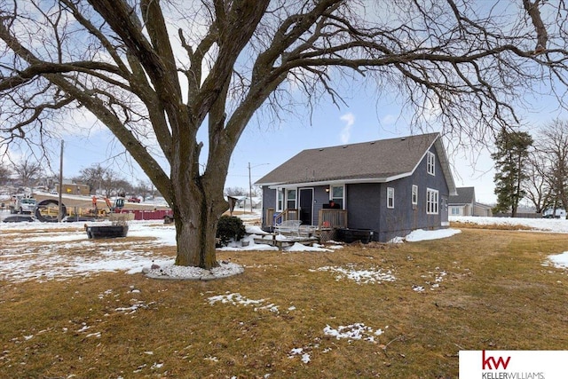 view of snow covered back of property