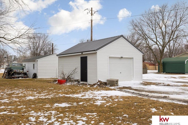 snow covered garage with a garage