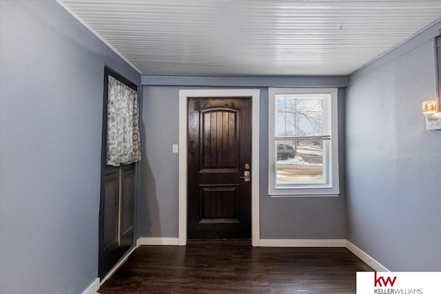 foyer entrance featuring dark wood-type flooring and baseboards