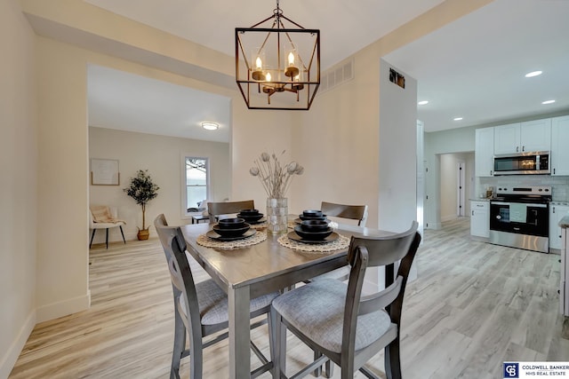 dining area with light wood-style floors, baseboards, visible vents, and recessed lighting