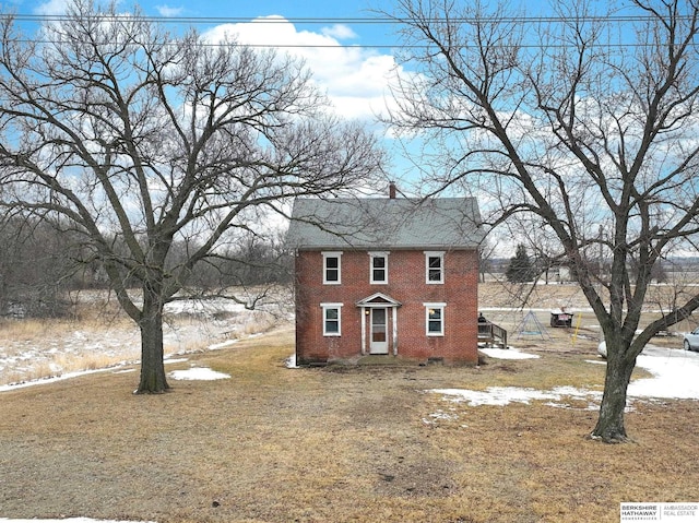 view of front of home with a front yard and brick siding