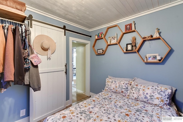 bedroom featuring ornamental molding, wooden ceiling, and a barn door