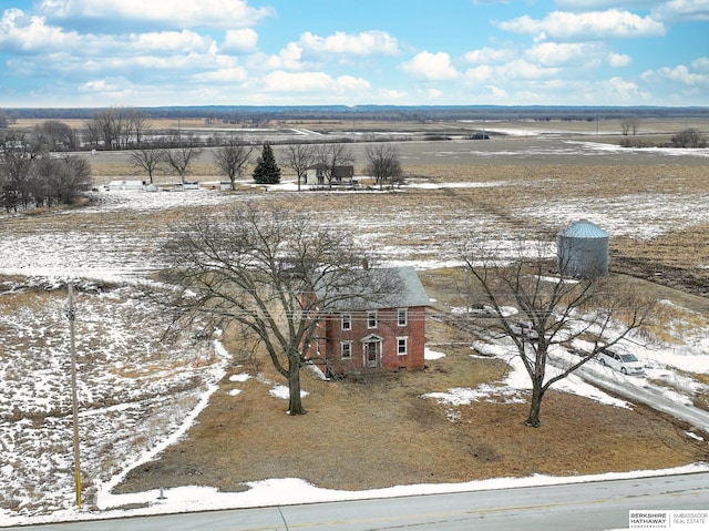 snowy aerial view featuring a rural view