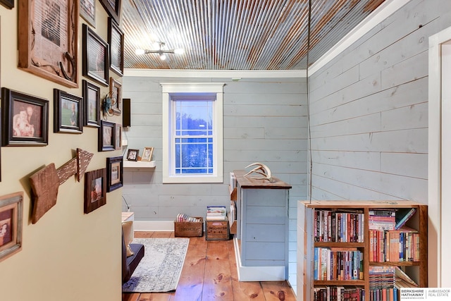 miscellaneous room with wooden walls and hardwood / wood-style floors