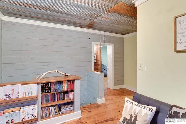 sitting room featuring wood walls, wood-type flooring, and wooden ceiling