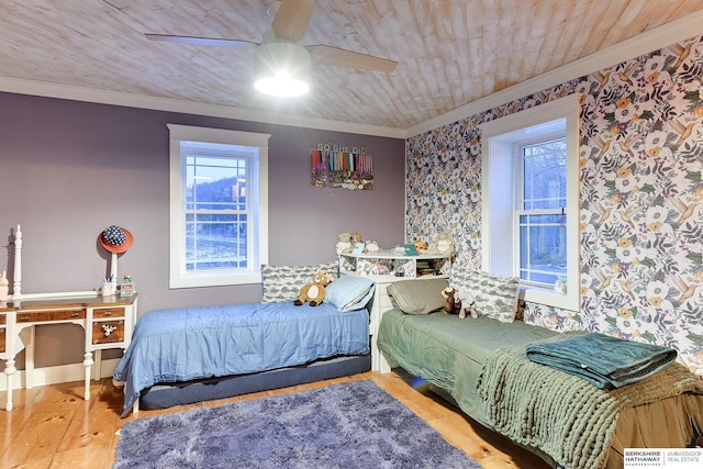 bedroom featuring ceiling fan, ornamental molding, wood finished floors, and wood ceiling