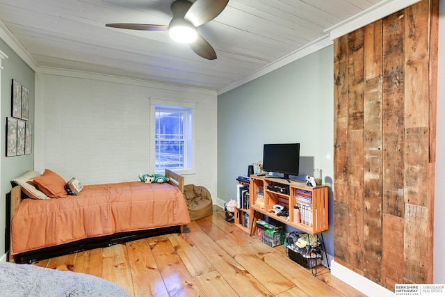 bedroom featuring ornamental molding, brick wall, ceiling fan, and hardwood / wood-style floors