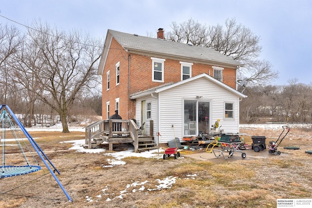 rear view of house with brick siding and a chimney