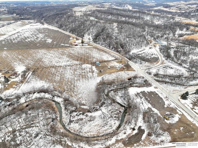 snowy aerial view featuring a mountain view