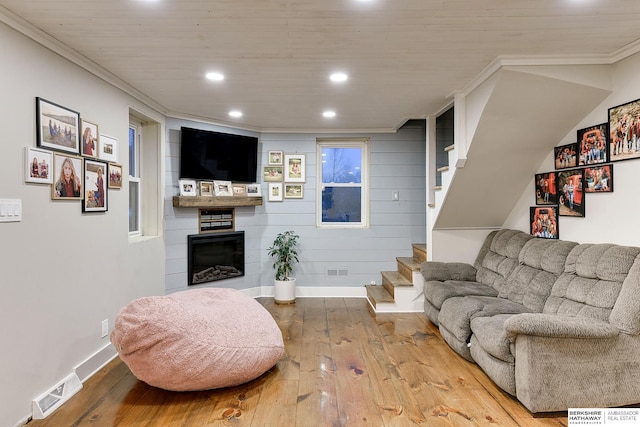 living room featuring recessed lighting, a fireplace, visible vents, stairway, and hardwood / wood-style floors