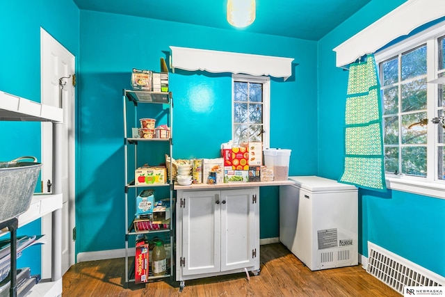 washroom with baseboards, visible vents, and wood finished floors