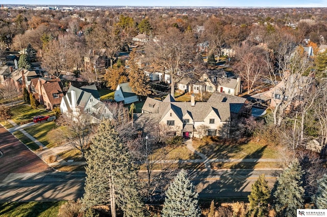 drone / aerial view with a residential view and a wooded view