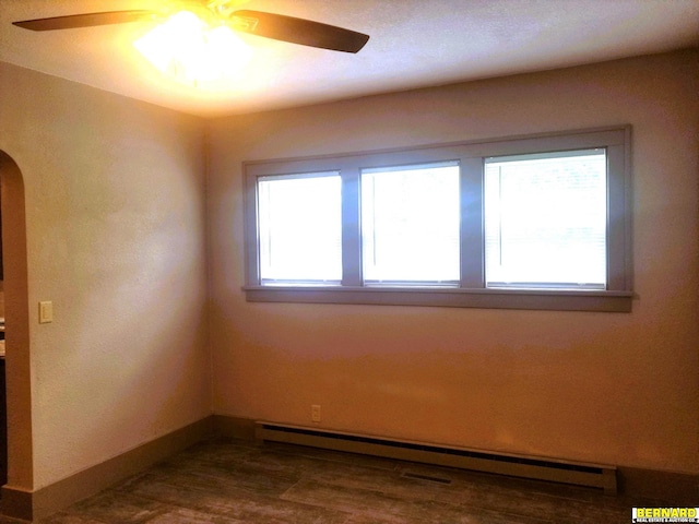 unfurnished room with arched walkways, baseboards, ceiling fan, and baseboard heating