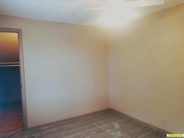 empty room with carpet floors, baseboards, and a ceiling fan