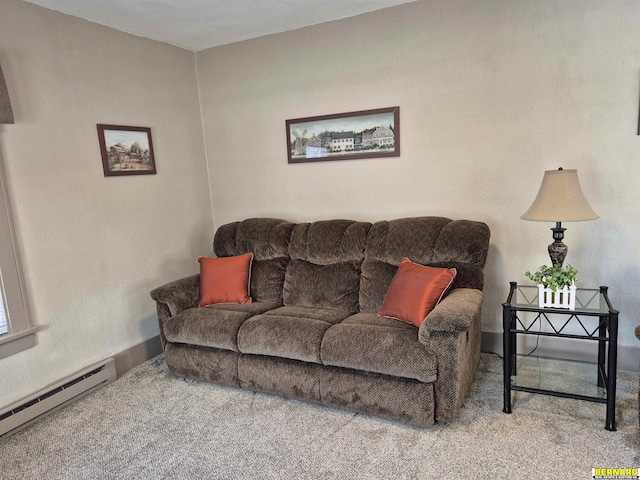 living area with a baseboard heating unit and carpet