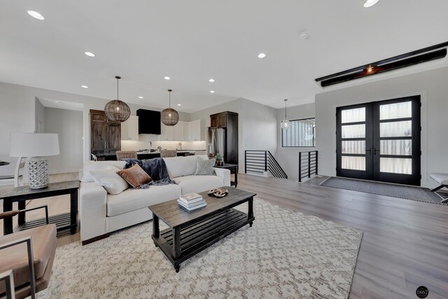 living room featuring recessed lighting, french doors, and light wood finished floors