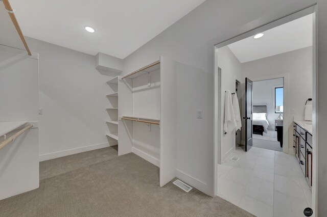 spacious closet with light carpet and visible vents