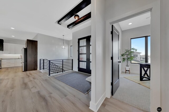 foyer with recessed lighting, light wood-style flooring, baseboards, and french doors