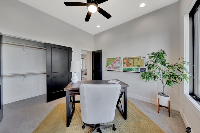 dining space featuring baseboards, a ceiling fan, and light colored carpet