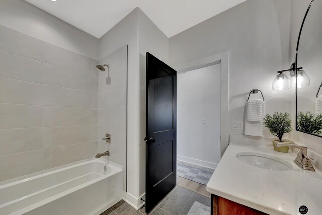 bathroom featuring vanity, baseboards, and bathing tub / shower combination