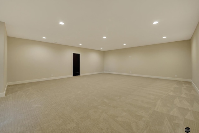 spare room featuring light carpet, baseboards, and recessed lighting