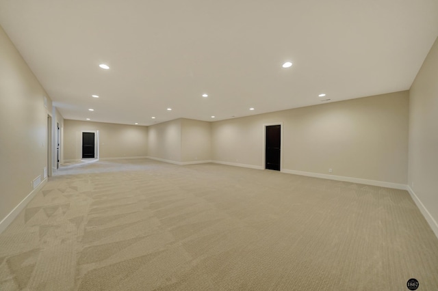 interior space with recessed lighting, light carpet, visible vents, and baseboards