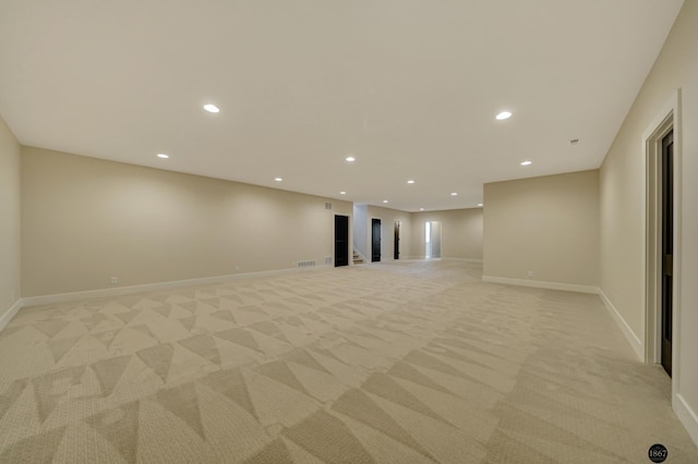 below grade area featuring recessed lighting, light colored carpet, and baseboards