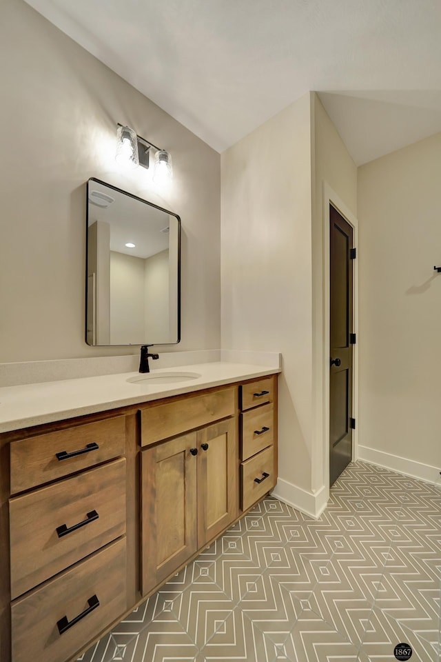 bathroom featuring baseboards and vanity