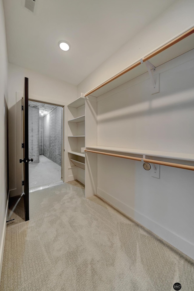 spacious closet featuring carpet flooring and visible vents