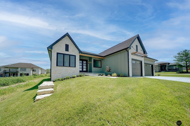 view of front of property featuring board and batten siding, a garage, stone siding, driveway, and a front lawn