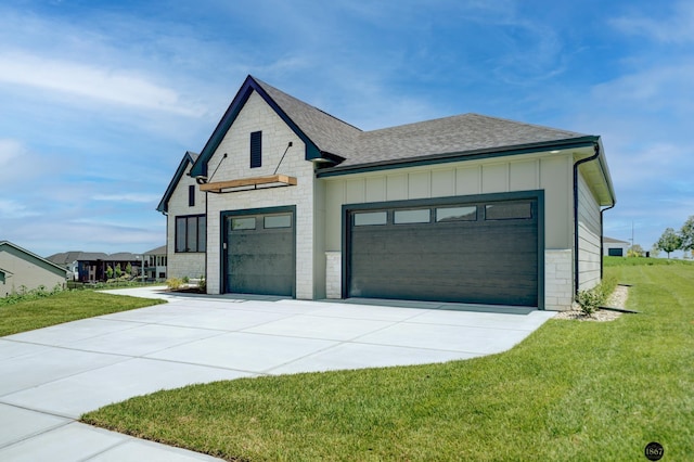 view of front of house featuring an attached garage, concrete driveway, stone siding, board and batten siding, and a front yard