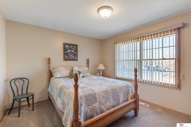 carpeted bedroom featuring visible vents and baseboards