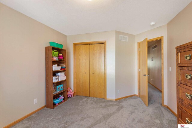 bedroom featuring carpet, a closet, visible vents, and baseboards