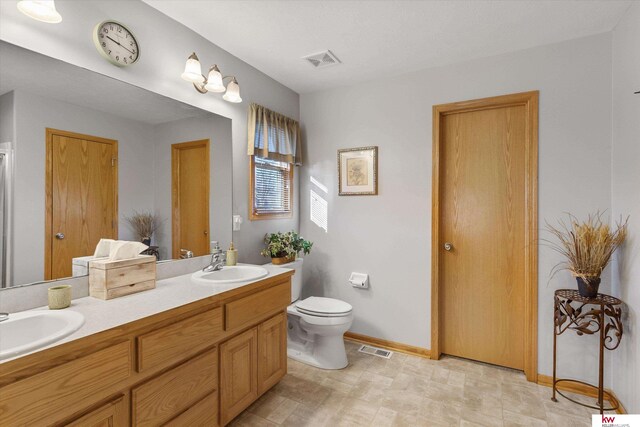 bathroom featuring visible vents, a sink, and toilet