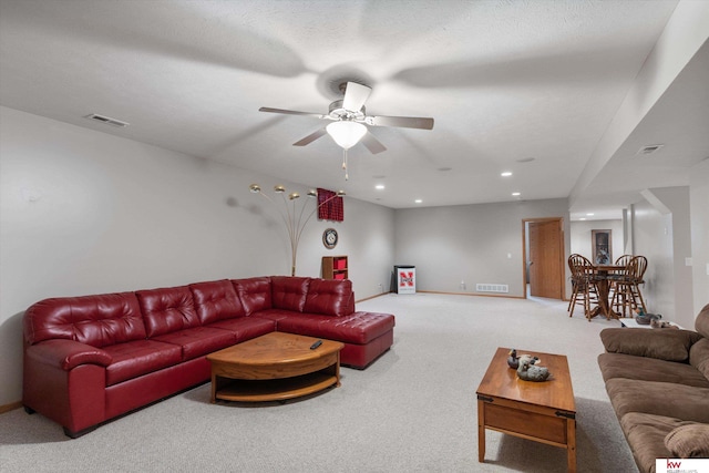 living room with carpet, visible vents, baseboards, and recessed lighting