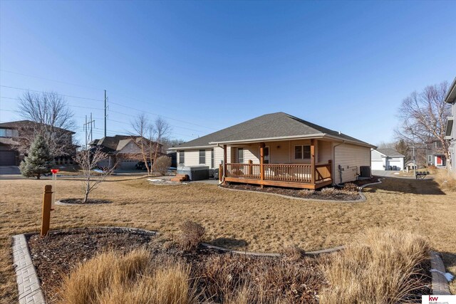 view of front of property featuring central AC and roof with shingles