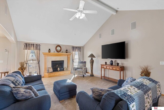 living area with light colored carpet, visible vents, a tile fireplace, beamed ceiling, and baseboards