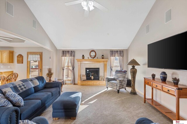 living room featuring light carpet, ceiling fan, visible vents, and a tile fireplace